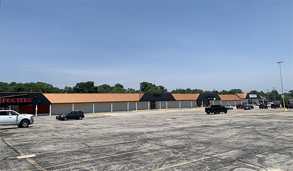 photo of 1 large building with big parking lot.